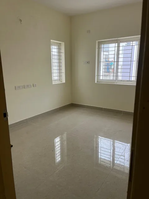 Bedroom four with two windows and polished tile flooring
