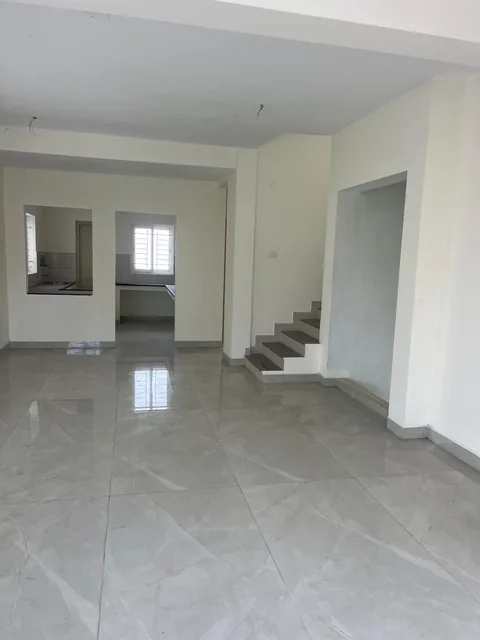 The open living area looking towards the kitchen and staircase